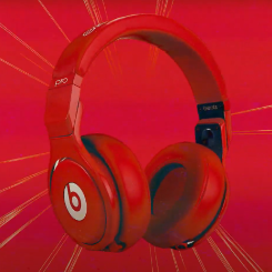 Red Beats over-the-ear headphones over a red background
