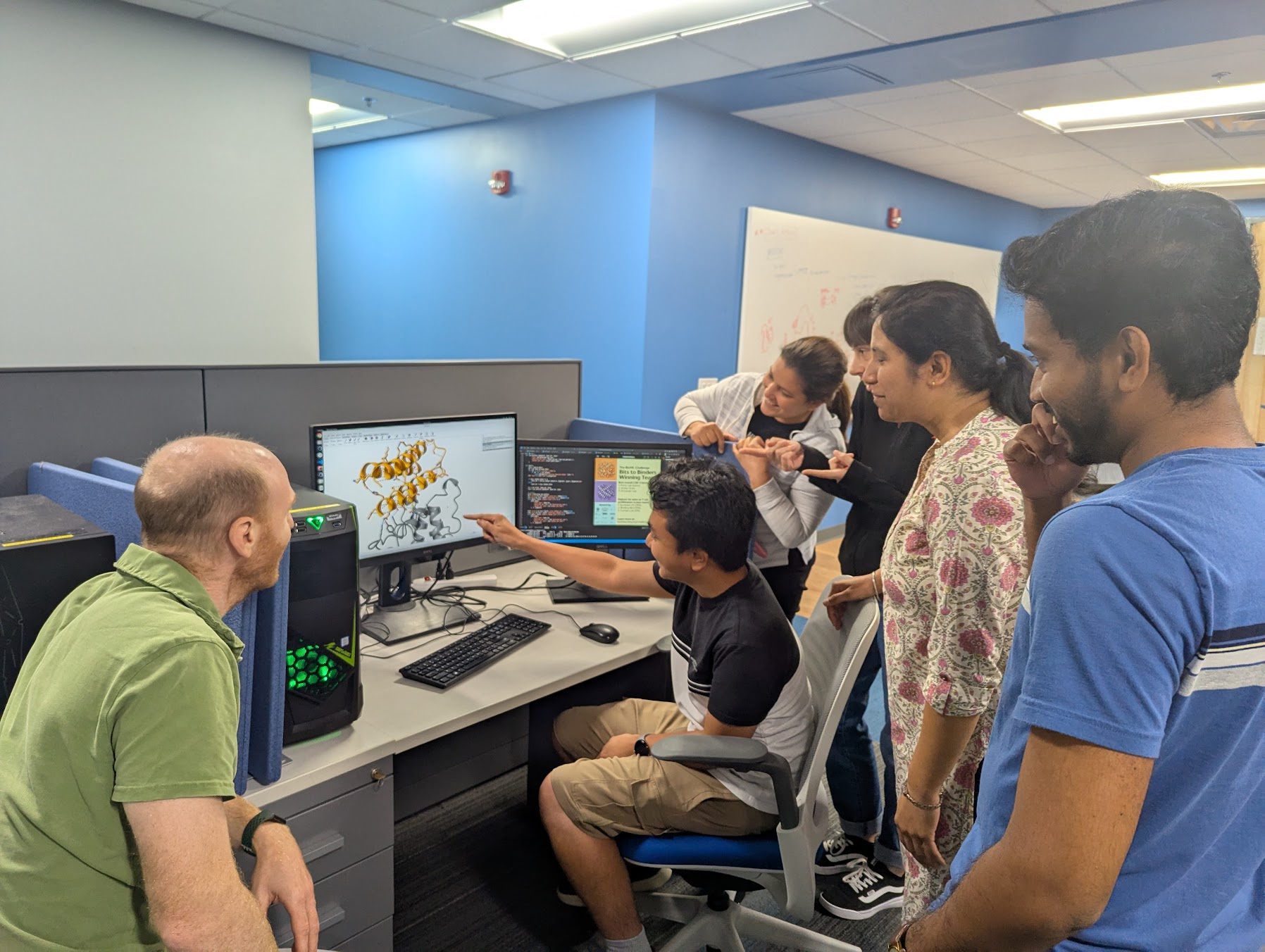 University of Florida students gathered around a desktop.